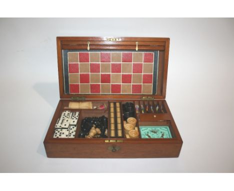 GAMES COMPENDIUM in a fitted mahogany box, containing a wooden chess set, draughts, dominoes, cribbage board, horse racing ga