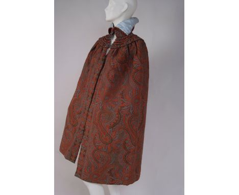 A VICTORIAN PAISLEY CAPE A cape made from a Victorian paisley shawl in different shades of orange, blue and dark brown. Lined