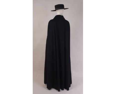 A VINTAGE BLACK WOOL CLOAK & BLACK FELT SPANISH HAT A full length soft wool cloak, fastened at the front with toggles and fou