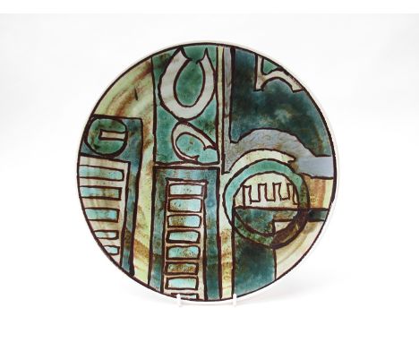 A 1960's Poole Studio plate with geometric design in Morris style, blue and green colours.  Blue back stamp.  (Minor nibbles 