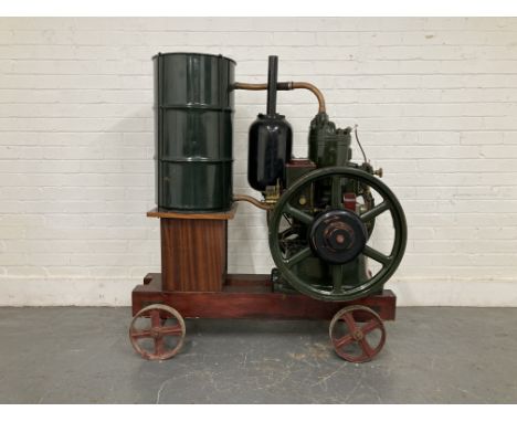 A Petter Universal 'M' Type oil enginenew model number 76362; 5 B.H.P; 600 R.P.M, restored and repainted dark green with red 