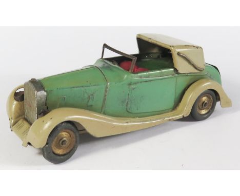 A Scarce Triang Minic 50ME Rolls Royce Sedanca in light green and beige with red plastic. The opening rear boot reveals a bat
