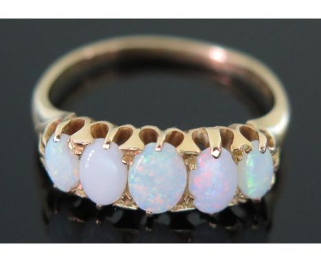 An 18ct Yellow Gold and White Opal Five Stone Ring, size U, 5.1g 