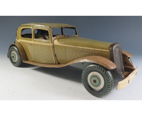 A Large Scale Mettoy Clockwork Tinplate Car in Olive Green with cream detailing and light brown sideboards, motor works (36cm