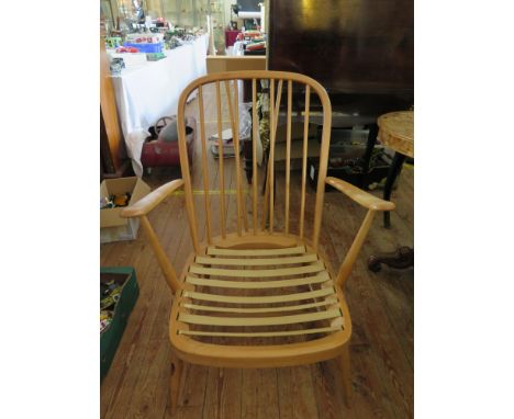 An Ercol Light Elm Spindle Back Open Arm Chair