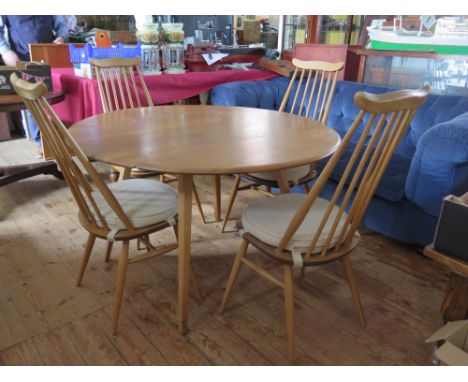 An Ercol Light Elm Drop Leaf Table with four spindle back chairs