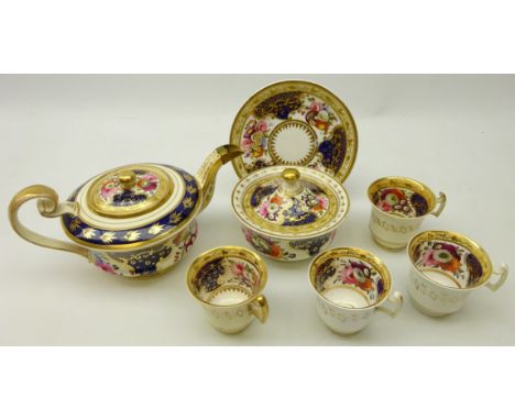 Early 19th century part tea set, decorated with a cobalt blue ground with gilt bordered reserves enclosing painted sprays of 