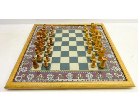 Oak framed tapestry chessboard with carved wood chess pieces, 66cm x 66cm    Condition Report   Click here for further images