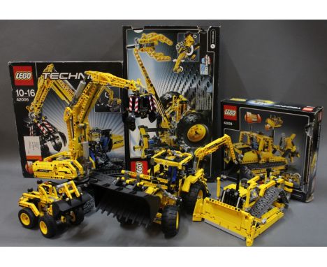 A group lot of Lego Technic model construction vehicles to include a 2-in-1 model excavator/tractor with box, and other Lego 