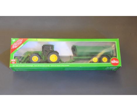 A Siku 1:32 scale John Deere 6820 tractor with front loader and a half-pipe rear twin axle tipping trailer, boxed 