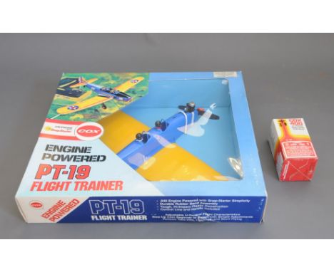 A boxed Cox engine powered PT-19 flight trainer (No. 5700) complete with a Cox 400 all-purpose model engine starting kit