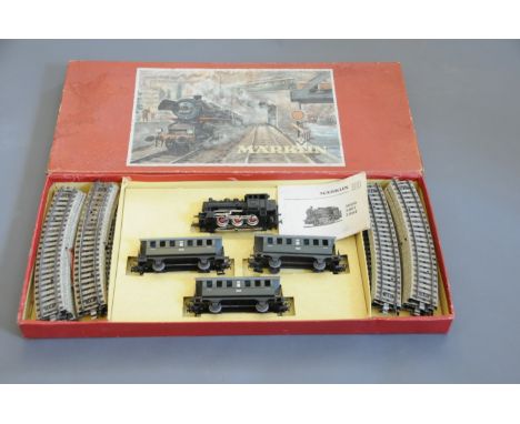 A Marklin German HO scale 3100 train set, comprising a 0-6-0 tank locomotive, 3 Personenwagens, and track