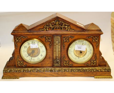 A Victorian mantle clock and barometer in oak case with cylindrical drum movement and brass decoration, in working order with