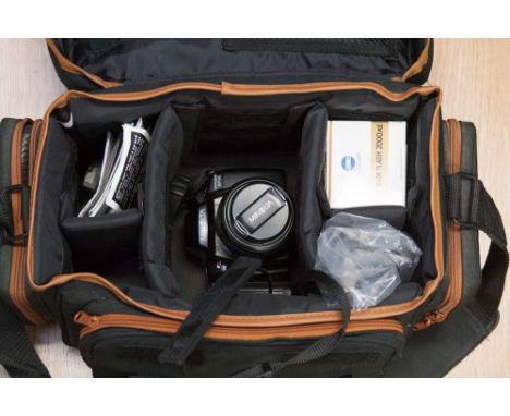 A Minolta camera in soft carry case, with flash, etc 