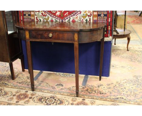 A George III mahogany side table originaly a card table. circa 1790, raised on square tapered legs.