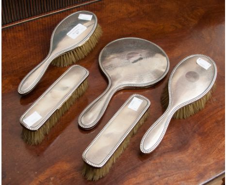 A silver backed five piece engine turned dressing table set, circa 1920s, Chester and Birmingham hallmarks 