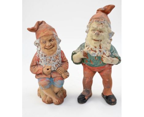 A pair of late Nineteenth/early Twentieth Century German terracotta gnomes, modelled as one smoking a pipe and the other seat