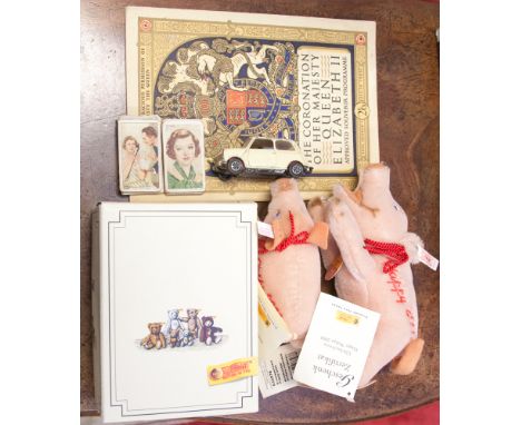 A box containing Steiff cigarette cards, Coronation ware, two Steiff piglets embroidered Happy 2000, corgi mini 