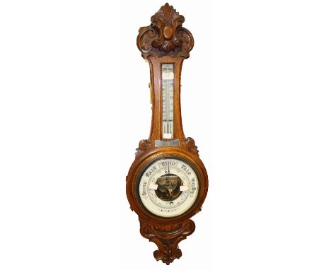 A George V oak cased aneroid barometer, bears presentation plaque