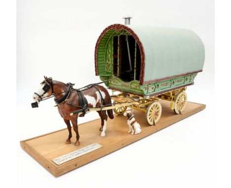 A 1/8th scale bow top caravan and Skewbald Horse on plinth 