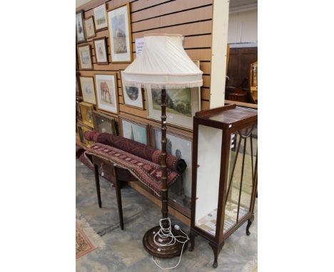 A 20th Century standard lamp, the cream shade raised on a turned column, standing on a circular base