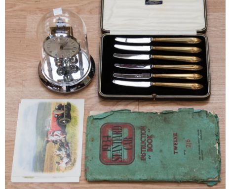 A 1934 standard car instruction book (no. 12 vehicle) together with a box of fruit knives and anniversary clock (3) 
