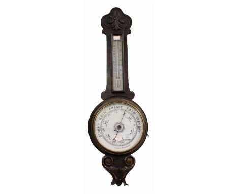 An Edwardian oak cased aneroid barometer
