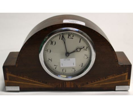An Art Deco mahogany and inlaid mantle clock, with a wind up mechanism 