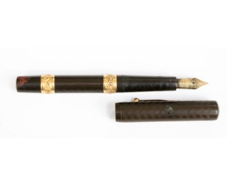 An early Twentieth Century Waterman fountain pen, engine turned black resin with gilt bands and 'ideal' nib, marked Canada, p