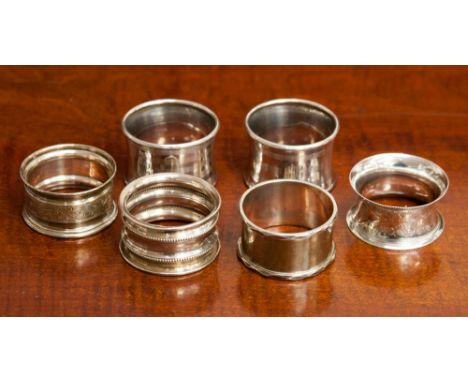 A pair of sterling silver Art Deco engine turned serviette rings, hallmarked for Birmingham; together with four others, two m
