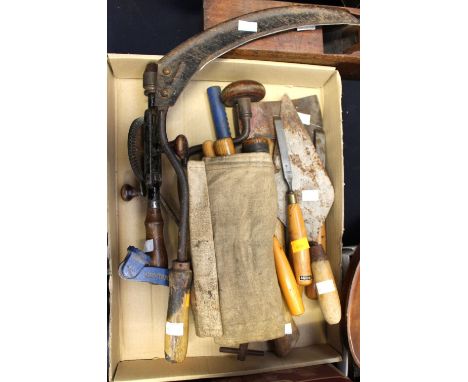 A collection of tools to include hand drill, wood working chisels and trowels, axe and hand sickle (q) 