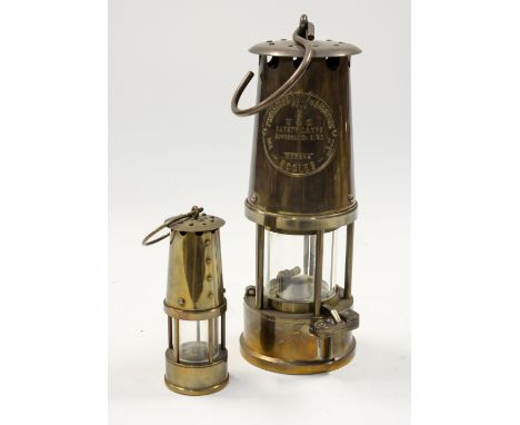  A Davey lamp, together with a novelty miniature miner's lamp. (2)