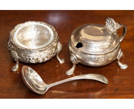 A Victorian sterling silver salt cellar, in the Georgian style with flared gadroon border, on three hoof feet, embossed folia