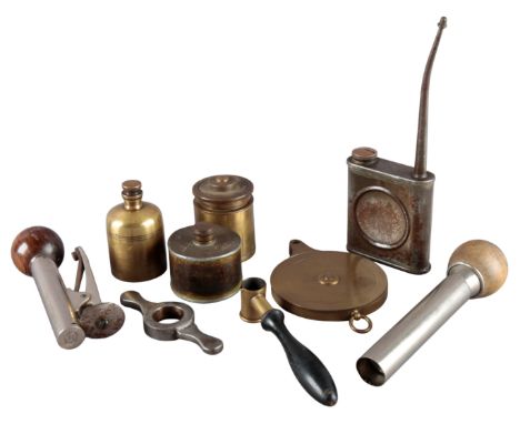 A QUANTITY OF CARTRIDGE RELOADING AND GUN CASE TOOLS including a case drummer, powder measure, oil bottles, striker pit, case