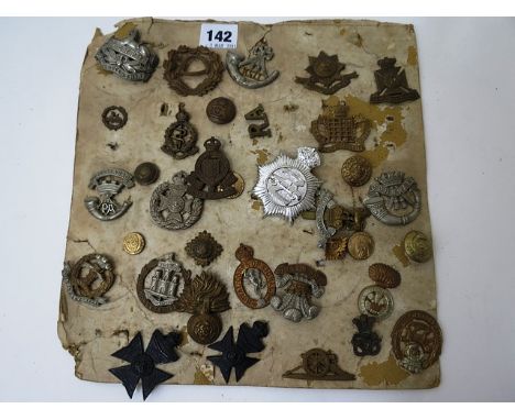 A collection of military badges mounted on card to include Royal signals, Dorset regiment and Army ordnance