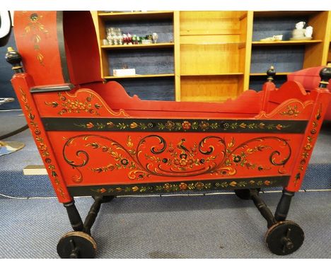 A Dutch hand painted red and black crib having all over floral decoration, signed R H