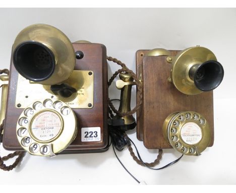 A vintage wall hanging telephone, mahogany casing and matching extension telephone