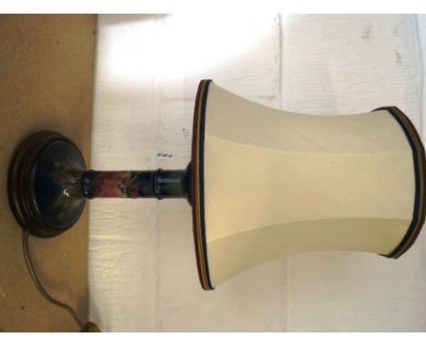 A Moorcroft candlestick lamp decorated with bird and fruit, standing on a raised circular base, 12 high