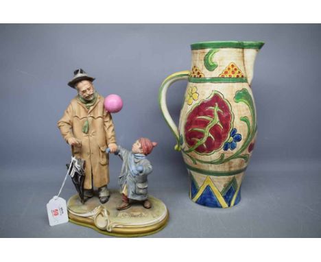 Capo di Monte figure group of a bearded man and a parasol, holding a young child, signed D Merli, together with a Falcon ware
