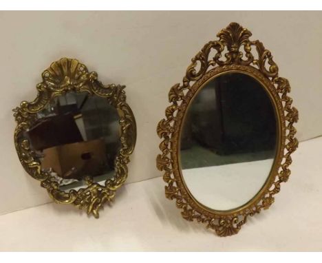 20th Century cast metal oval mirror with easel back, together with a further brass small hanging mirror with cherub detail an