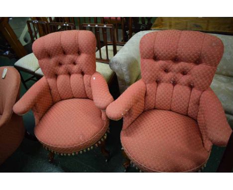 Pair of 19th century oak armchairs with puce upholstered seat and button backs, raised on cabriole legs with brass casters  