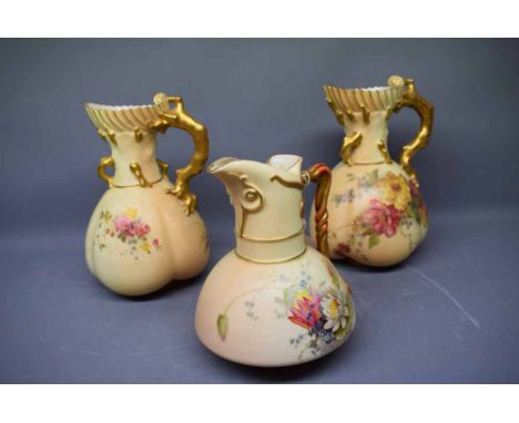 Three Royal Worcester blush ivory ewers with floral decoration, shaped handles, Shape no 1378, together with a pair of Worces