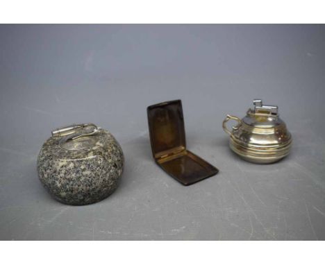 Miniature granite and silver topped curling stone, together with a silver table lighter in the form of a small chamber stick 