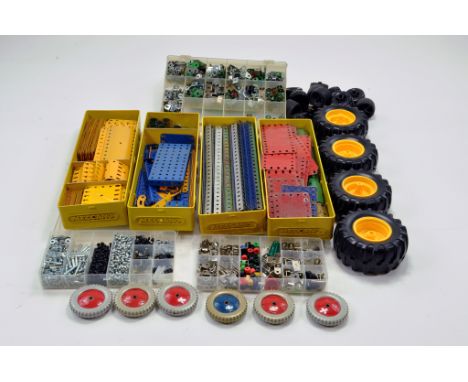 A large quantity of Meccano components, tools, parts and accessories. Various colour combinations in wooden shelf trays, set 