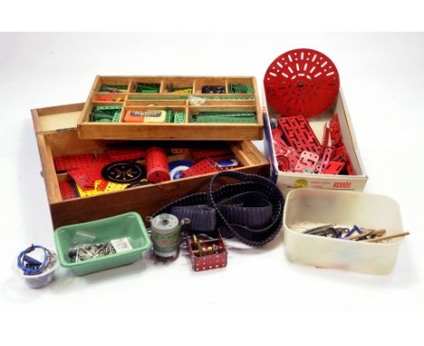 A large quantity of Meccano components, tools, parts and accessories partly contained in wooden unit / chest. Various colour 