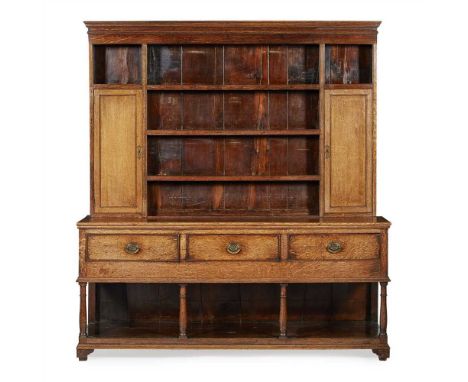 GEORGIAN OAK DRESSER 18TH CENTURY the moulded cornice above open shelves with an enclosed back and flanked by panel doors; th