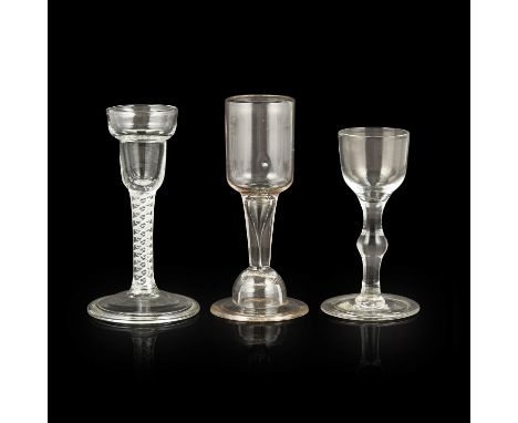 THREE GEORGIAN WINE GLASSES 18TH CENTURY comprising an example with a pan top, enamel twist and folded foot, 14cm high; an og