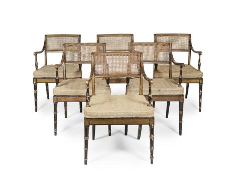 SET OF SIX REGENCY EBONISED AND PARCEL GILT ARMCHAIRS BY JOHN GEE EARLY 19TH CENTURY the scroll caned panel backs above caned