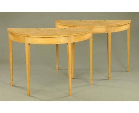A pair of Edwardian style demi lune inlaid and painted console tables, each raised on four tapered legs of square section ter