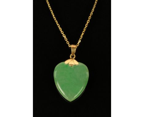 A 9 ct gold mounted green jade heart shaped pendant, the mount stamped 14K and with gold coloured chain. CONDITION REPORT: Th